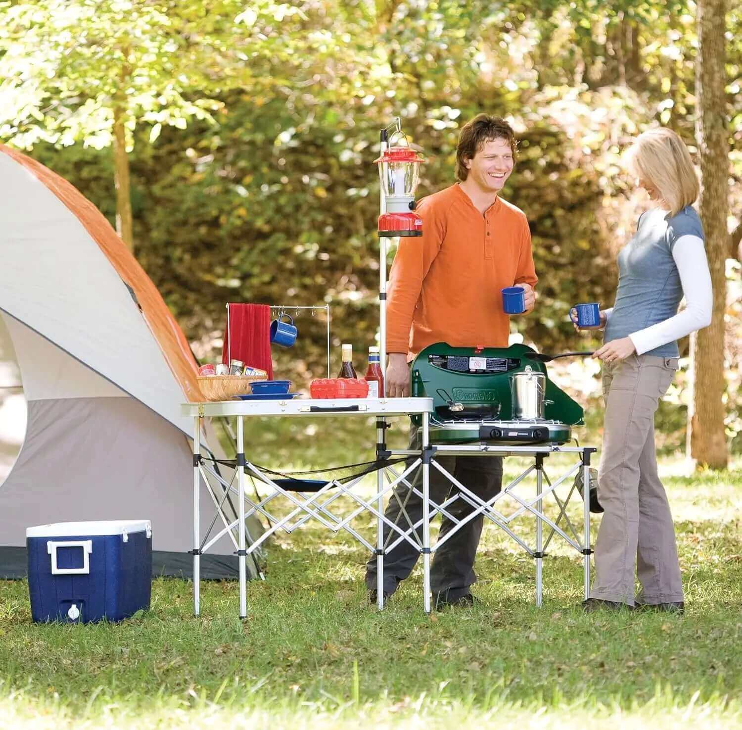 {{Camping Gear {{ Hiking Gear }} }} - {{Tac Treasure Shop }} {{ Coleman}} {{ Couple using table to cook }}