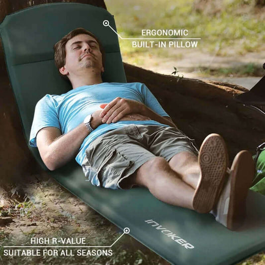 {{Camping Gear {{ Hiking Gear }} }} - {{Tac Treasure Shop }} {{ Foam sleeping pad with ergonomic built in pillow. A gentleman napping under a tree on the mat.}}